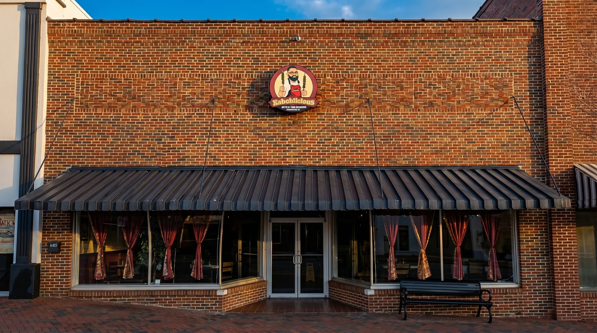 The Kaboblicious storefront on the square in downtown Clarkesville, Georgia, with its red brick facade and charcoal awning
